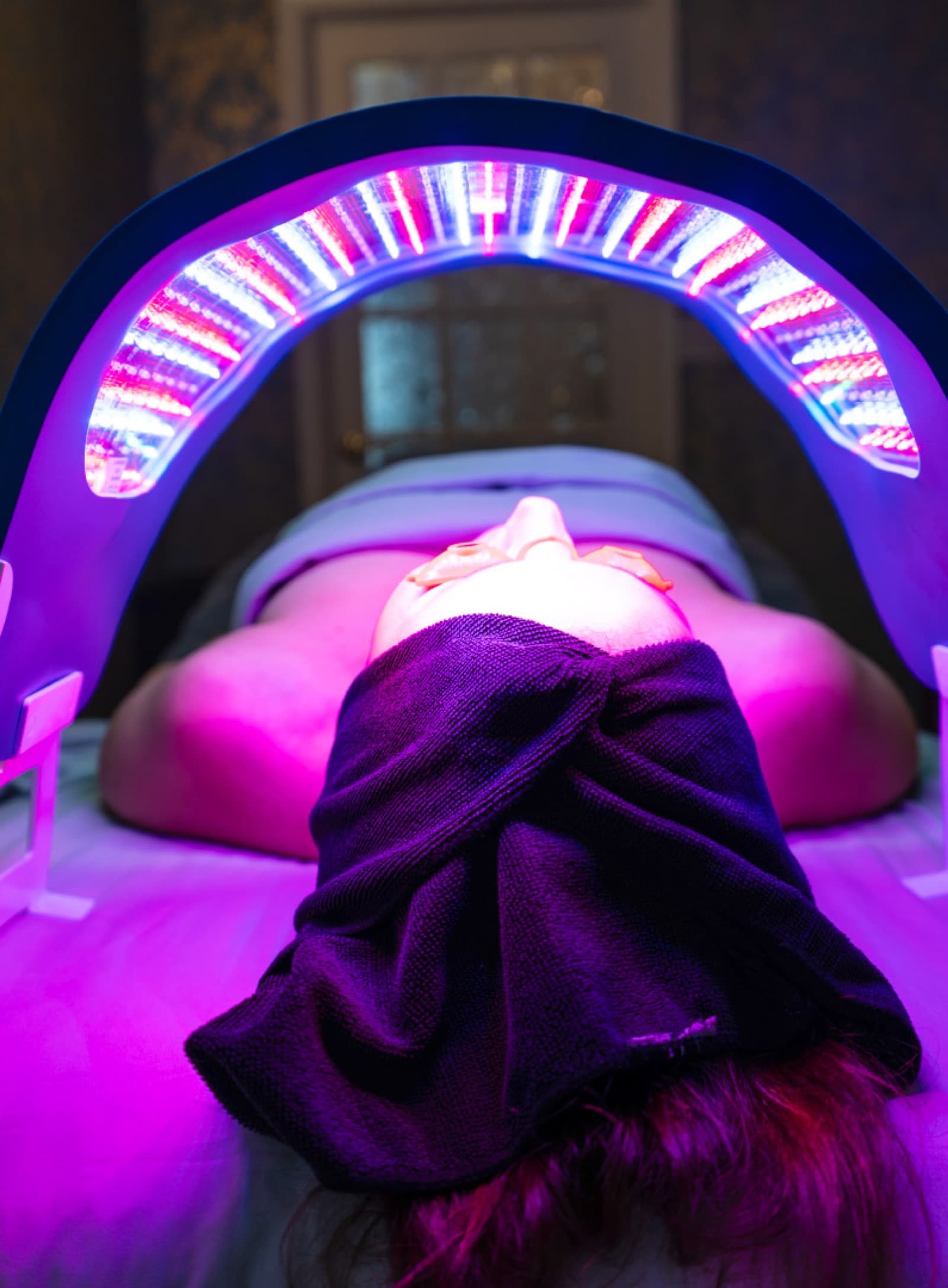 LED light therapy over a guest's face during a facial at LNO Boutique in Centennial