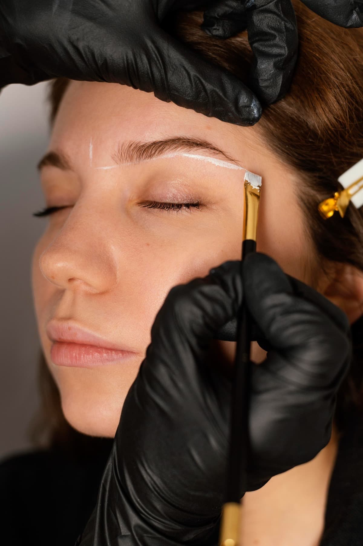Eyebrow tint being brushed onto the brow with a fine angled brush at LNO Boutique in Centennial, Denver