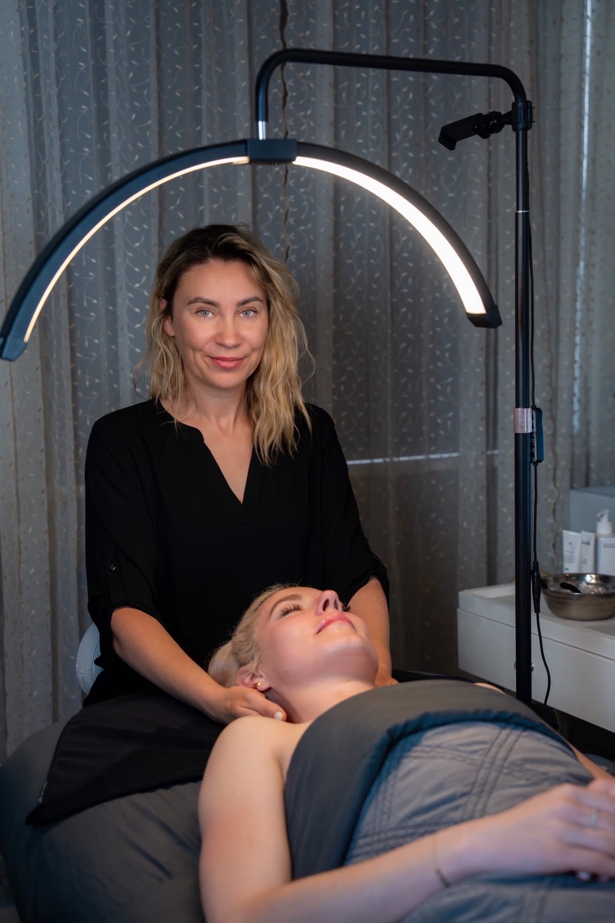 Professional aesthetician performing lymphatic drainage facial massage at LNO Boutique in Centennial