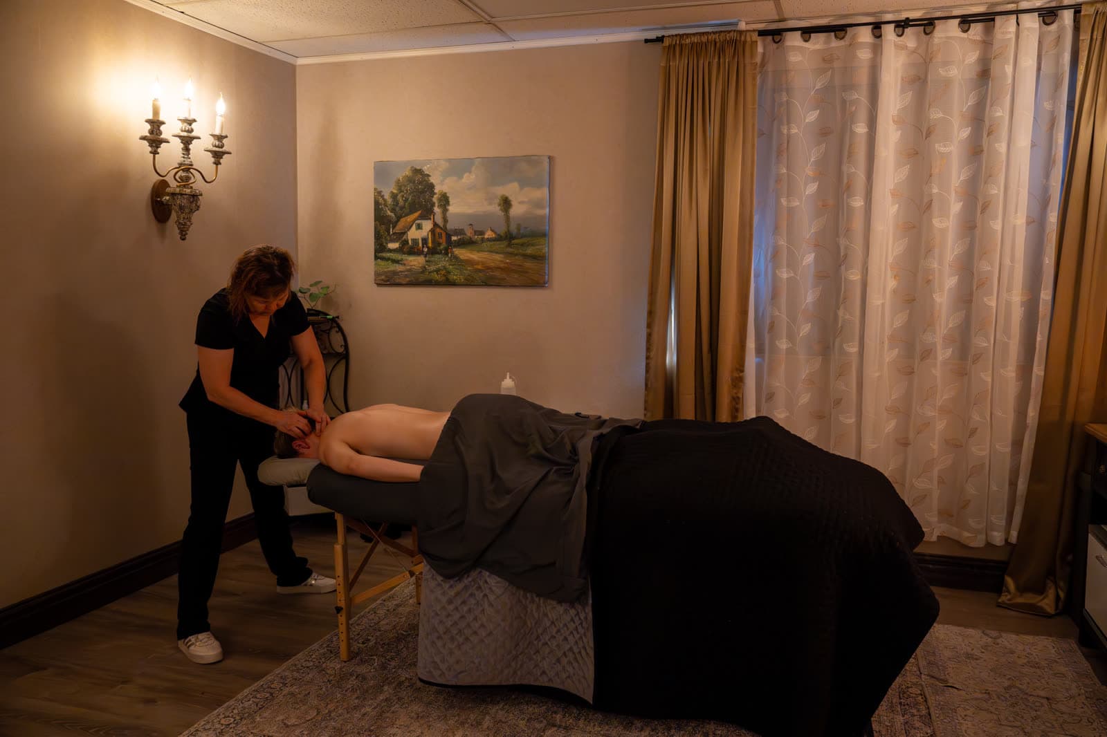 Deep tissue massage of the shoulders and neck in a treatment room at LNO Boutique, Centennial