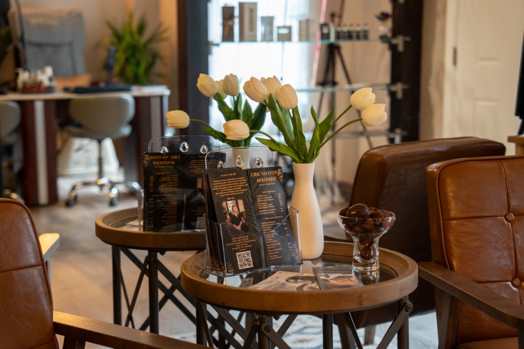 Lounge chairs and white tulips in the lobby of LNO Boutique day spa in Centennial, Colorado