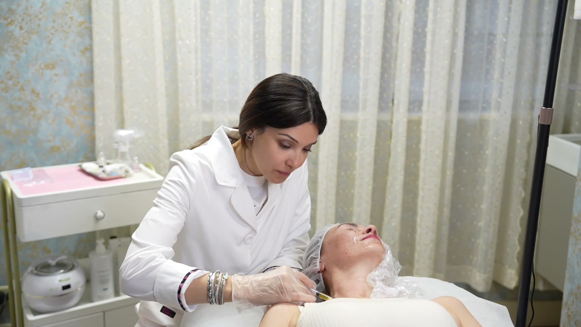 Aesthetician applying platelet-rich plasma to a client's face during PRP therapy