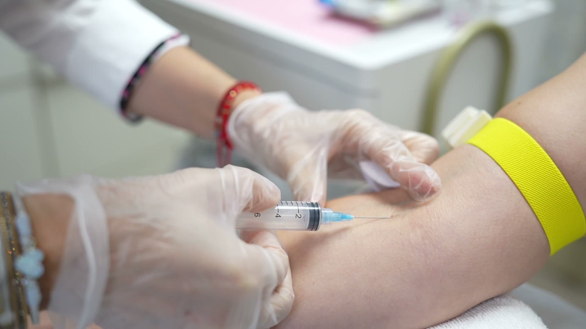 PRP specialist drawing a small blood sample for platelet-rich plasma therapy