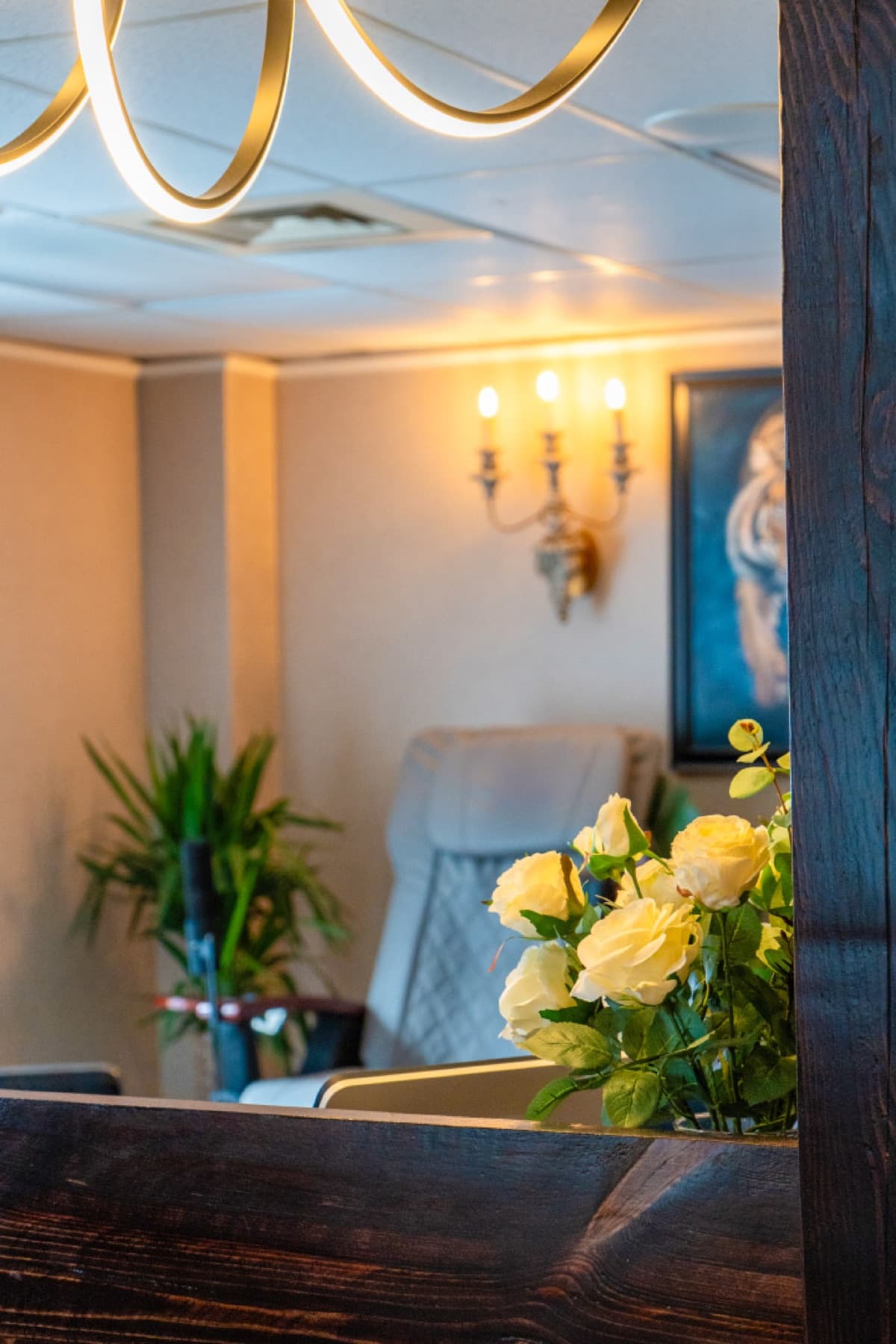 Gold chandelier and candle sconces in the lobby of LNO Boutique med spa in Centennial, Denver